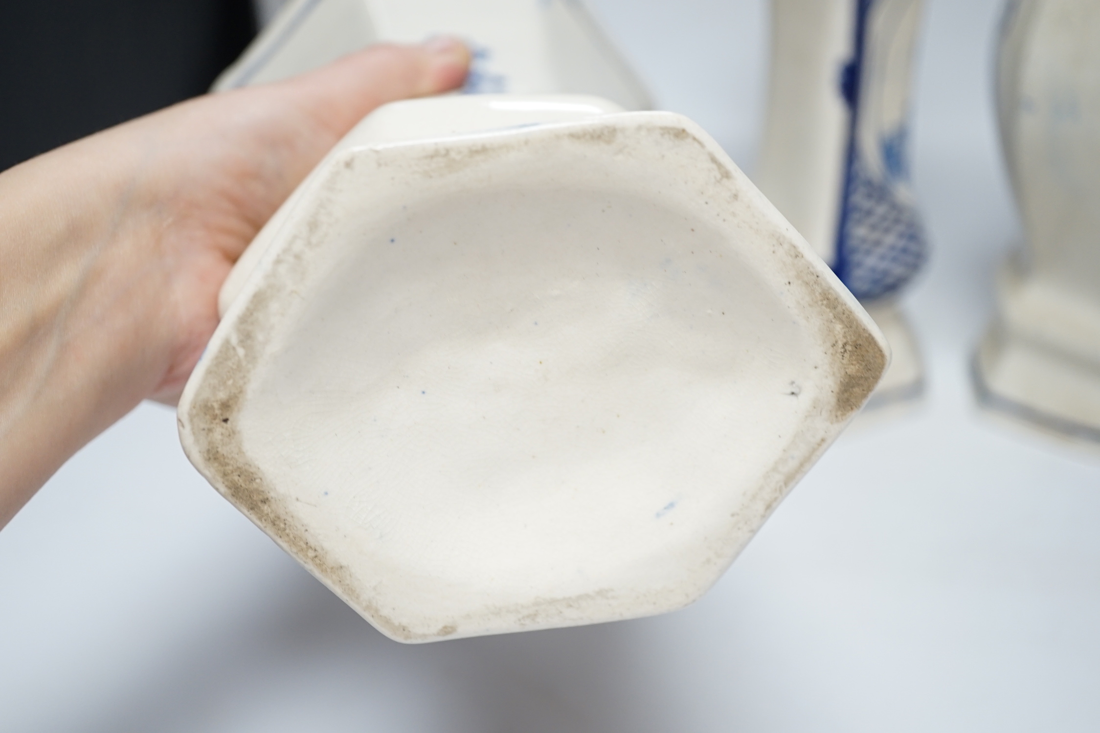 A trio of cream and blue glazed pottery vases, one with cover, tallest 34cm high